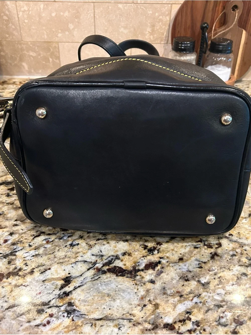 Dooney & Bourke Black Leather Drawstring Backpack with Yellow Stitching
